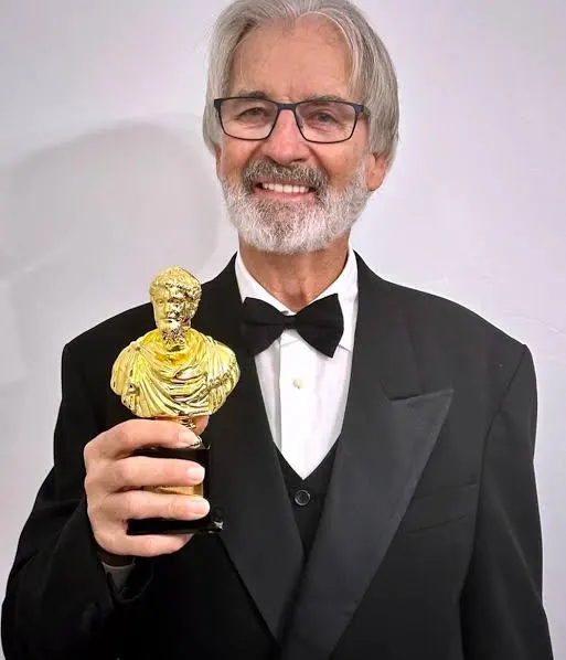 John Jarratt, Chief Executive Officer of Big Hit Films, holding the Septimius Award for Best Oceanian Actor